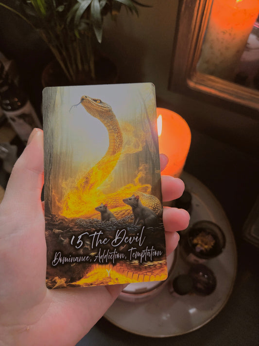 The Devil tarot card showing a serpent with golden light, representing dominance, addiction, and temptation
